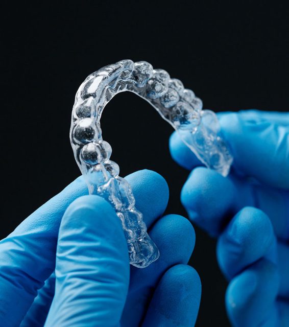 holding a clear aligner tray